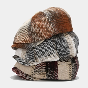 British vintage herringbone flat cap set in tweed textures with various plaid patterns
