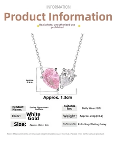 Detailed view of silver heart necklace with pink and white pear-cut zircon pendants