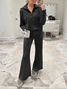 Detail of black two-piece lounge set with half-zip sweatshirt and wide-leg trousers