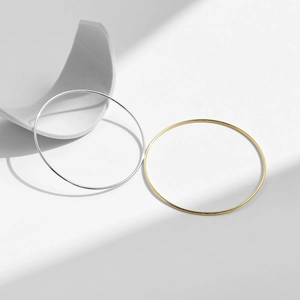 Minimalist S925 sterling silver smooth bangles in gold and silver finishes on white