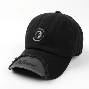 Detail of distressed brim and 3D embroidered D letter on vintage patchwork baseball cap