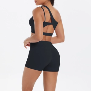 Detail of black one-shoulder yoga set with cutout back design and high-waist shorts