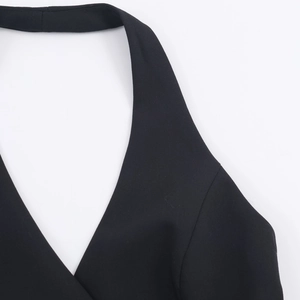 Detailed view of black halter neckline and precise stitching on the tailored vest top