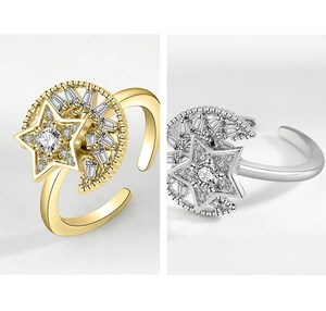 Macro shot of rotatable gold and silver star moon rings with sparkling zircon stones