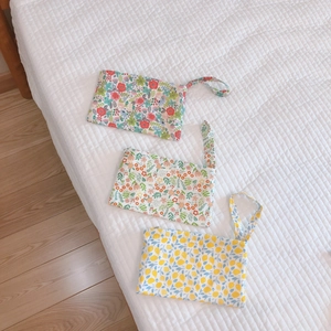 Floral cotton mini pouches with wristlets in citrus and blossom patterns for storage