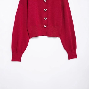 Deep red cropped knitted cardigan featuring unique silver heart-shaped embossed buttons