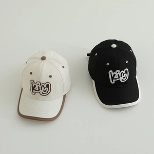 Close-up of kids baseball caps featuring king embroidery and contrast piping details