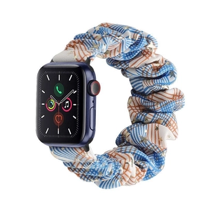 Detail of blue plaid scrunchie watch band with gold star patterns for Apple Watch