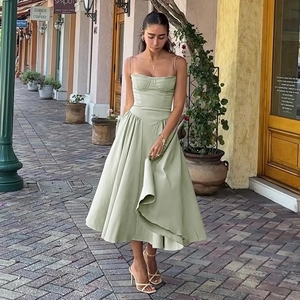 Detail of elegant green A-line sundress with a corset bodice in an outdoor European street