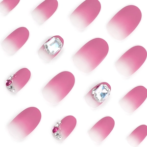 Short matte ombre press-on nails in pink with rhinestones and crystal heart accents