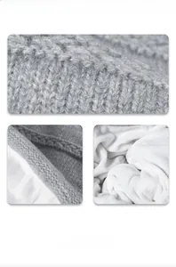 Detail of dark grey knit texture and thick white fleece lining for winter thermal hat