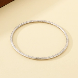 Detailed macro view of 3mm antique silver stackable stainless steel minimalist bangle