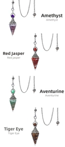Detail view of crystal pendulums in amethyst, red jasper, aventurine, and tiger eye stone