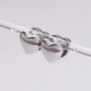 Elegant heart-shaped stainless steel stud earrings with silver stripe texture on gray