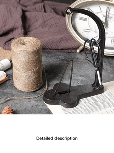 Close-up of vintage cast iron twine holder stand with scissors in nostalgic setting