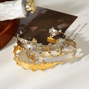 Detail of vintage French style gold and silver open bangles with bark texture and bead edges