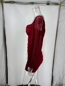Detail of burgundy mesh bodycon dress featuring pleated design and long sleeves