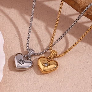 Close-up of heart pendant necklace with octagonal star engraving and zircon inlay