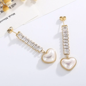 Elegant gold earrings with baguette zircon and hanging heart-shaped pearl drop