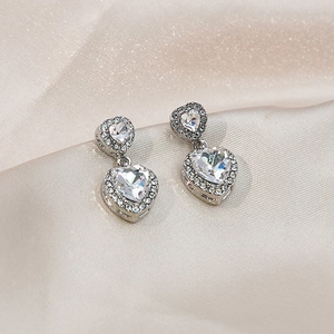 Elegant silver heart-shaped drop earrings with sparkling cubic zirconia on silk base
