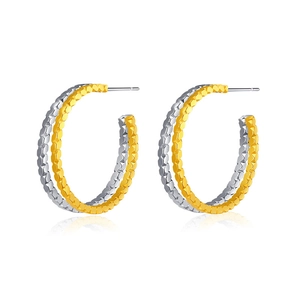 Chic two-tone gold and silver hoop earrings with a textured honeycomb finish and punk design