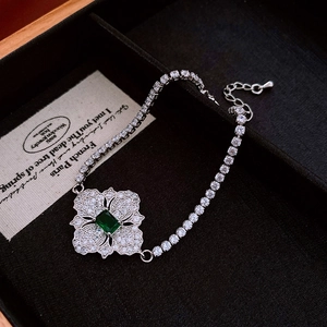 Detailed view of zircon rhombus flower necklace on black velvet inside a wooden jewelry box