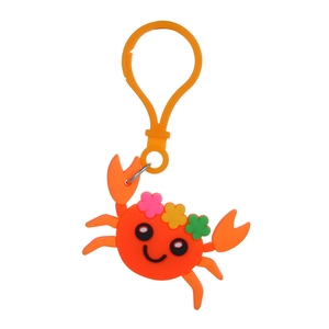 Close-up of orange PVC crab keychain with colorful flower details and plastic clip