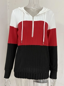 Detail of the half-zip knitted hoodie showing tri-color splicing and ribbed texture