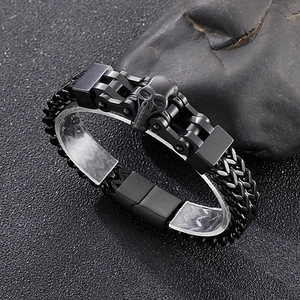 Close-up of black punk motorcycle chain bracelet with skull relief for men