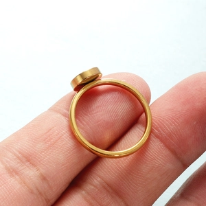 Minimalist gold stainless steel ring with flat round blank surface shown on finger