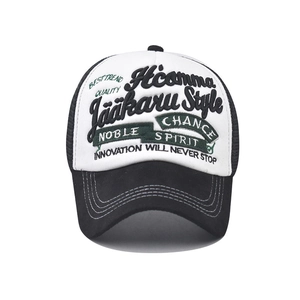 Close-up of 3D embroidery and breathable mesh detail on this black and white trucker hat