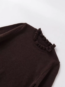 Close-up of dark brown knit sweater featuring detailed ruffled neckline and soft texture