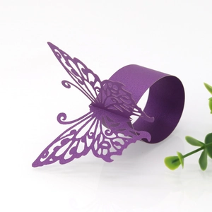 Macro detail of laser-cut purple butterfly napkin ring with pearlescent paper finish