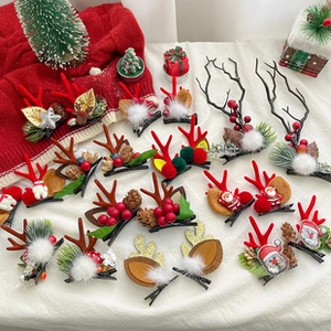 Detail shot of Christmas hair clips with reindeer antlers, pine cones and red berries
