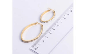 Detail of 4.5cm 18K gold plated oval earrings with sparkling crystal pavé settings