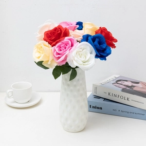 Colorful artificial gypsophila and rose bouquet in a white textured vase for home decor