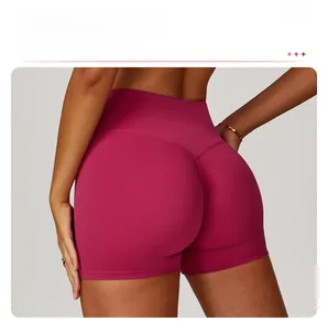 Detailed view of high waisted dark magenta yoga shorts with scrunch butt lifting texture