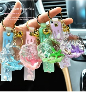 Acrylic shell keychain with colorful sequins, stars, and beads in a car interior setting