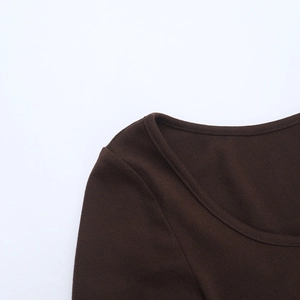 Détail de l'encolure ronde et des coutures de cette robe en maille ajustée marron foncé