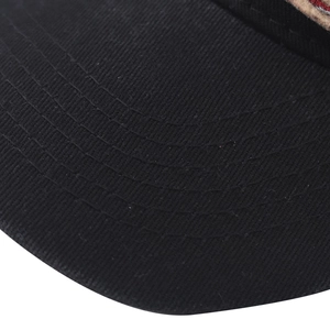 Detail of curved brim on black washed cotton baseball cap with five reinforced stitch lines
