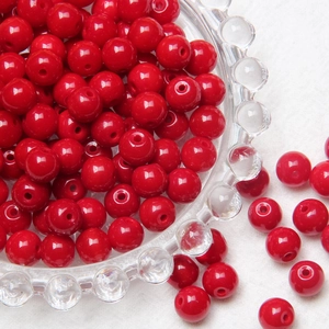 Macro detail of 8mm polished red round glass beads with holes for DIY jewelry making
