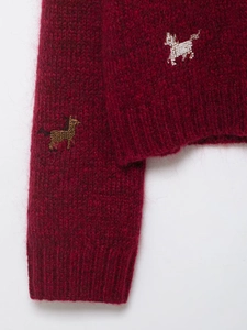 Close-up of wine red mohair knit sweater featuring intricate animal bead embroidery