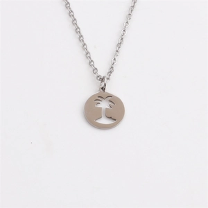 Close-up of silver stainless steel necklace with a hollow palm tree circular pendant