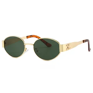 Oval gold metal sunglasses with dark green lenses and vintage hollow temple design