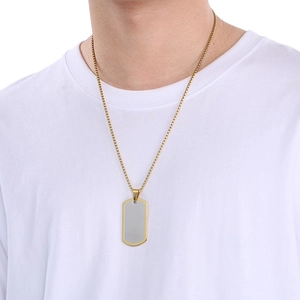 Detail of a square link chain with a rectangular silver pendant and gold trim edge
