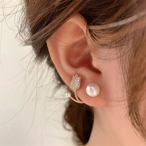 Elegant tulip pearl earrings with gold accents and sparkling cubic zirconia on a model
