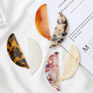 Detail of colorful acetate hair combs featuring marble patterns and tortoiseshell textures