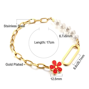 Detail of 18K gold plated stainless steel bracelet with pearl and red flower charm