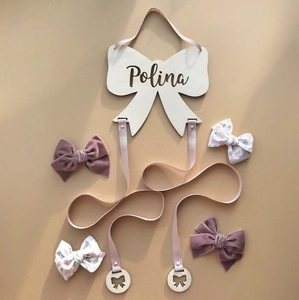 Detailed view of Polina personalized wooden bow hanger with pink ribbon hair accessory set