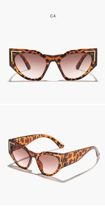 Close-up of leopard print cat eye sunglasses with gradient lenses and gold corner accents